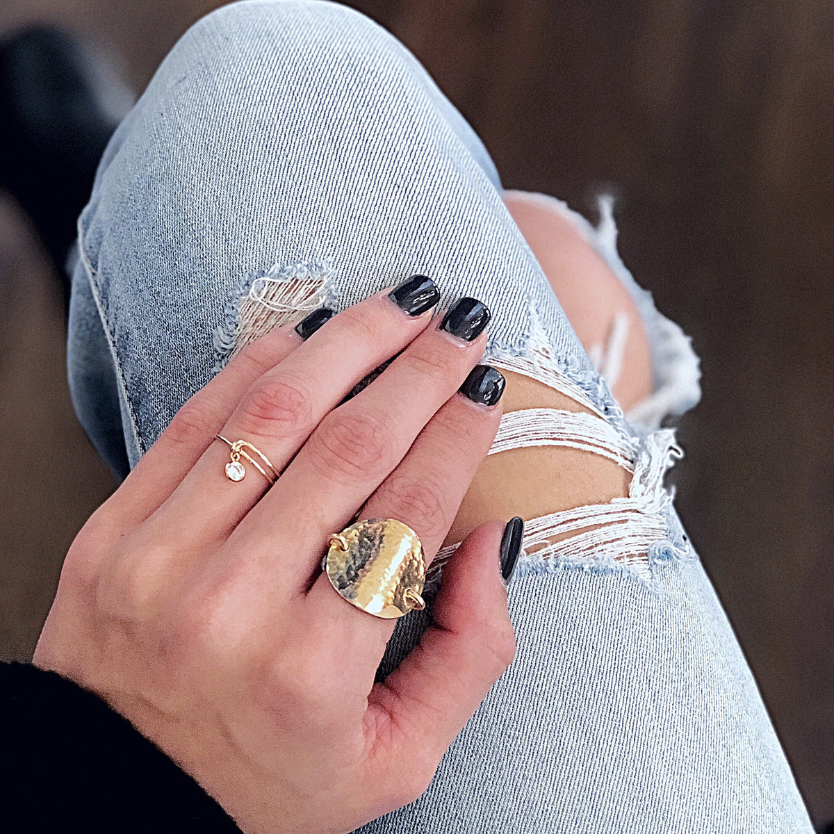 CZ Tiny Charm Ring Hand on Knee with hammered ring dainty cz shown adjustable 24k gold filled overhead view