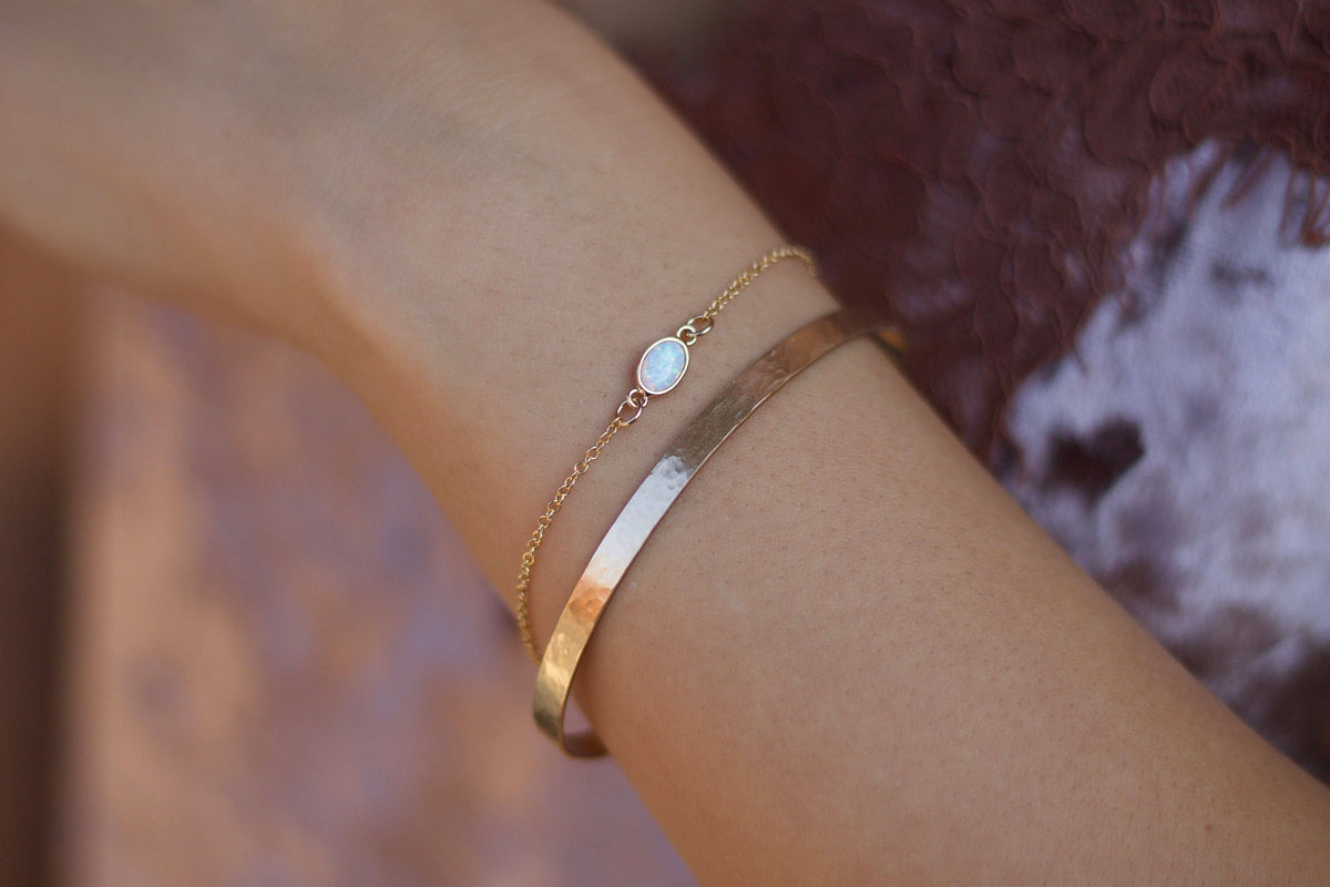 Dainty opal bracelet featuring genuine white fire opal stones with our layered cuff sold separately on a 14K gold-filled chain, perfect for everyday wear and water-friendly.