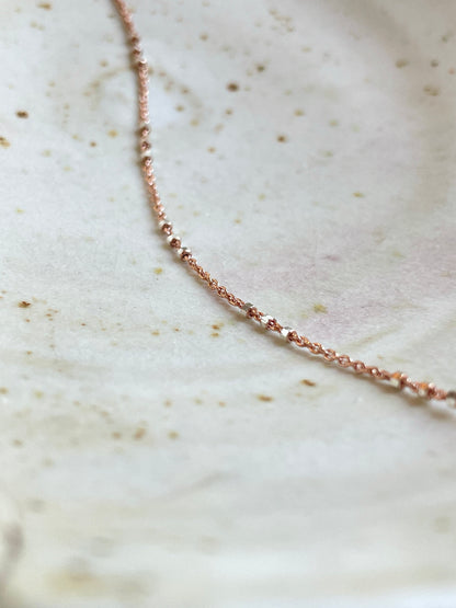 Two-tone Rose Gold and Sterling Silver satellite chain necklace featuring small silver beads spaced in sets of threes for a chic and contemporary look. This shows the details.